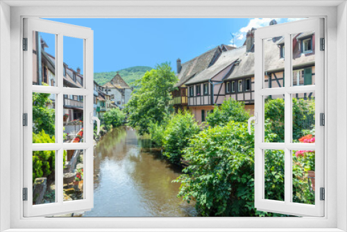 Fototapeta Naklejka Na Ścianę Okno 3D - A picturesque colorful view of half-timber buildings at a small creek in the village of Kaysersberg in Vosces region.