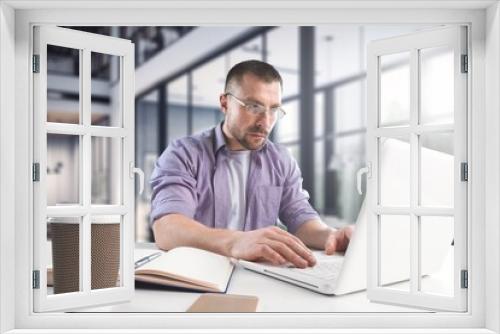 Cheerful male professional work on laptop