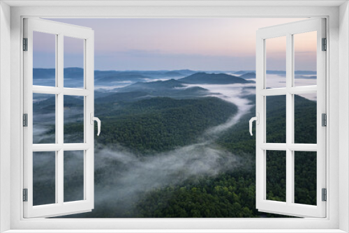 Fototapeta Naklejka Na Ścianę Okno 3D - Cumberland Gap through Cumberland Mountains, within Appalachian Mountains. Tripoint of Kentucky, Virginia, and Tennessee. Pinnacle Overlook at key passageway. Foggy sunrise