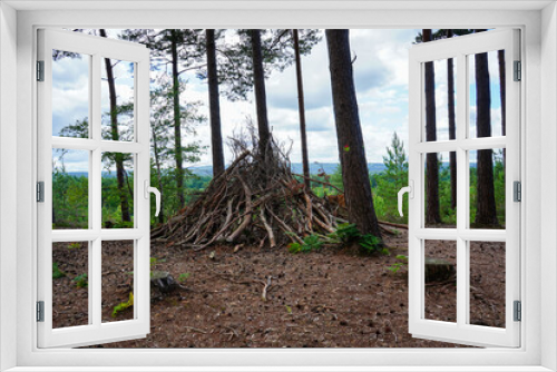 Fototapeta Naklejka Na Ścianę Okno 3D - Woodland hut made of twigs and logs