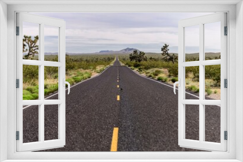 Fototapeta Naklejka Na Ścianę Okno 3D - Desert Serenity: Panoramic View of an Empty Road Surrounded by Red Rock Canyon After a Storm, Presented in Captivating 4K Resolution