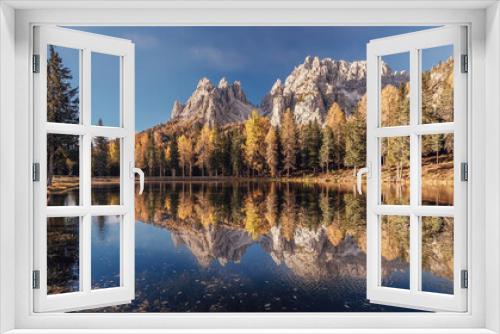 Fototapeta Naklejka Na Ścianę Okno 3D - Incredible autumn scenery with reflections. Amazing autumn landscape in the mountains with yellow larches and lake glowing by sun and high mountain peaks behind. Antorno lake. Picture of Wild area.