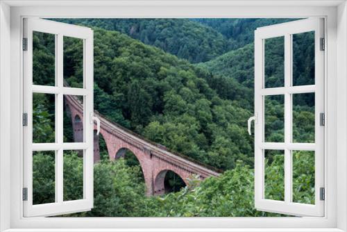 Fototapeta Naklejka Na Ścianę Okno 3D - old arch Bridge railway viaduct between hills in the green Forest Germany trees