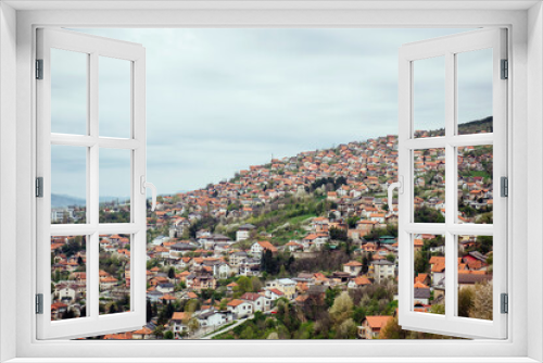 Panoramic view of the spring city of Sarajevo, Bosnia and Herzegovina. A trip to a European city in the mountains with orange roofs