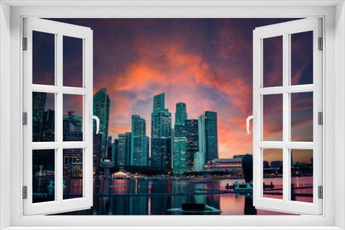 Fototapeta Naklejka Na Ścianę Okno 3D - Singapore Skyline in the evening with a dramatic sunset.
