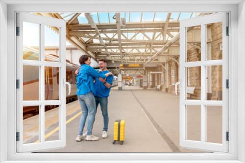 Beautiful couple at railway station waiting for the train. Woman and man running to board a train