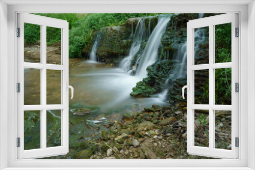 Fototapeta Naklejka Na Ścianę Okno 3D - waterfall in a mountain river of crystalline waters with green vegetation, silk effect