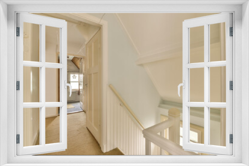 Fototapeta Naklejka Na Ścianę Okno 3D - a long hallway with white trim on the walls, and carpeted stairs leading up to an open door that leads to another room