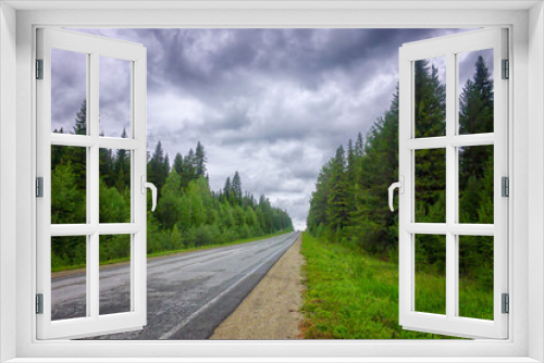 Fototapeta Naklejka Na Ścianę Okno 3D - Landscape asphalt road coniferous forest cloudy sky summer.