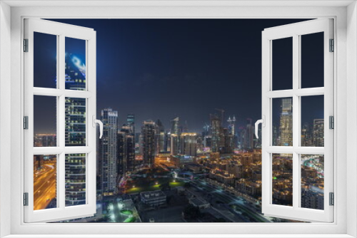 Fototapeta Naklejka Na Ścianę Okno 3D - Panorama showing Dubai Downtown and business bay night timelapse with tallest skyscraper and other towers