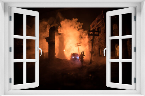 Fototapeta Naklejka Na Ścianę Okno 3D - Silhouette soldier carrying little boy on his shoulder from fire. Rescue savior concept. Man moving out with little boy from burned out city destroyed in war. Selective focus