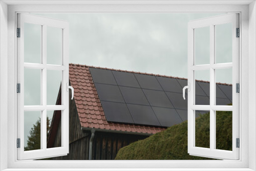 Fototapeta Naklejka Na Ścianę Okno 3D - Solar panels on a roof. Beautiful, large modern house and solar energy. Harnessing Clean Energy. Solar Panels on a Modern House