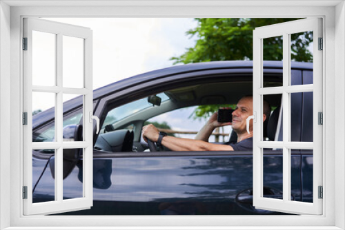 Man inside car speaking on phone