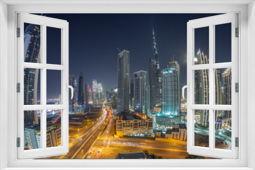 Fototapeta Naklejka Na Ścianę Okno 3D - Aerial view of Dubai Downtown skyline with many towers all night timelapse.