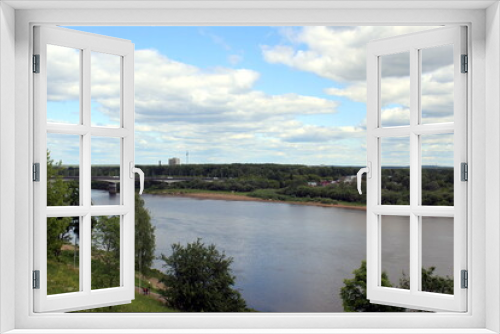 Fototapeta Naklejka Na Ścianę Okno 3D - Beautiful view of a flowing river in summer with trees and fields.