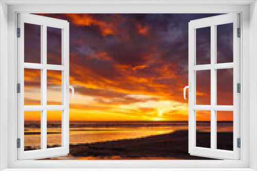 Fototapeta Naklejka Na Ścianę Okno 3D - sunset sky with reflections in water, sunlight and colored orange clouds. Magnificent view of the sea and sun in evening. travel and freedom, meditation, poster. amazing sunset light on ocean