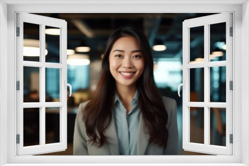 Portrait of happy asian woman smiling standing in modern office space. 