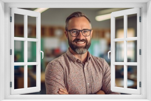 Handsome bearded man teacher in classroom with arms crossed, cheerful education from elementary to university