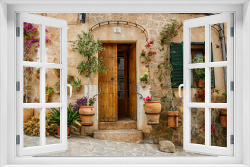 Fototapeta Naklejka Na Ścianę Okno 3D - Beautiful cozy typical entrance to the house with flowers in Valldemossa, Mallorca