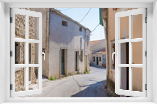 Fototapeta Naklejka Na Ścianę Okno 3D - Street with old buildings in Lakones village, Corfu, Greece