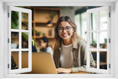 Smart Asian woman with stylish eyeglasses works in a busy office, smiling at the camera amid a blurred background. generative AI.