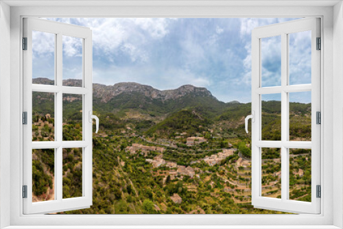 Fototapeta Naklejka Na Ścianę Okno 3D - The panoramic view of Deia at the Island Mallorca shows the treelined mountain high point near the ocean, Mountain and Bay on the mediterranean coastline,  skyline Serra de Tramuntana