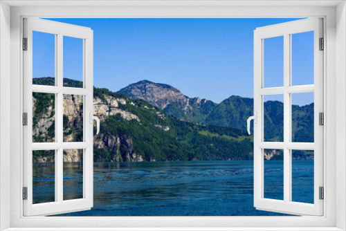 Fototapeta Naklejka Na Ścianę Okno 3D - Scenic view of mountain panorama at Lake Lucerne with Swiss village of Seelisberg on top of mountain on a sunny spring day. Photo taken May 22nd, 2023, Sisikon. Switzerland.