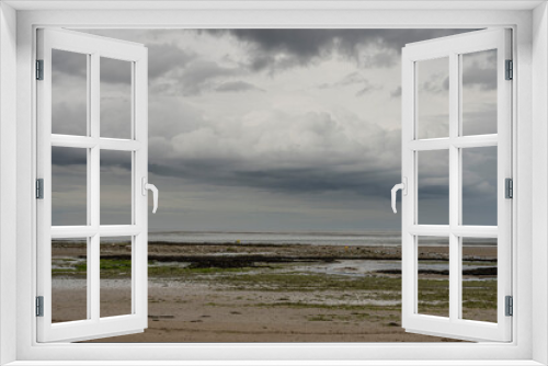 Fototapeta Naklejka Na Ścianę Okno 3D - Saint-Aubin-Sur-Mer, France - 07 16 2023:  View of a cloudy rainy sky above the sea from the beach.