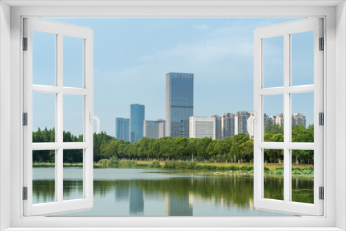 Fototapeta Naklejka Na Ścianę Okno 3D - Lakeside modern office building in China