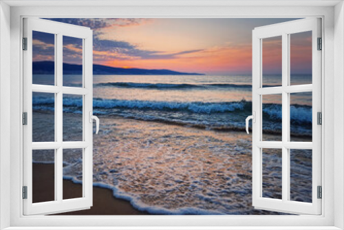 Fototapeta Naklejka Na Ścianę Okno 3D - Dawn at the sea with foamy waves on the sand and colorful sky at the horizon. Sunny Beach coastline in Bulgaria. Summer and travel background