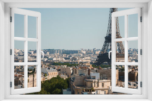 Fototapeta Naklejka Na Ścianę Okno 3D - Daytime photo of the Eiffel Tower in Paris, France under a clear blue sky.