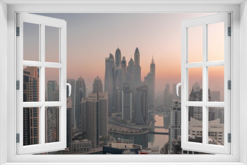 Fototapeta Naklejka Na Ścianę Okno 3D - View of various skyscrapers in tallest recidential block in Dubai Marina aerial night to day timelapse