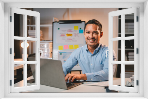 business man working late at night use laptop at desk Happy male portrait working IT, face and male coder or person programming Coding and Writing for Software or Information Technology Development