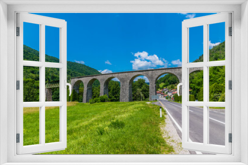 Fototapeta Naklejka Na Ścianę Okno 3D - A panorama view towards the railway viaduct at Bača near Modrej in Slovenia in summertime
