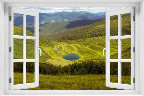 Fototapeta Naklejka Na Ścianę Okno 3D - landscape on a mountain lake and a clearing with green grass