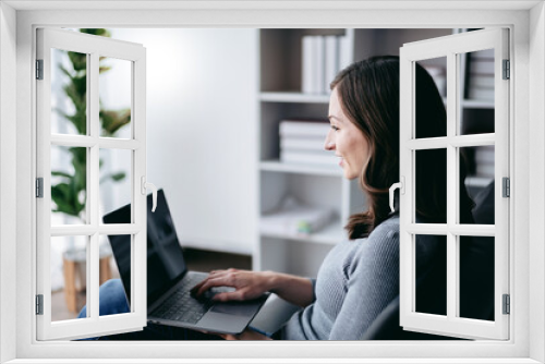 Businesswoman with technology lifestyle concept, Businesswoman using laptop to watching the movie while sitting on the couch to relaxation with technology after working