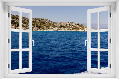 Fototapeta Naklejka Na Ścianę Okno 3D - Beautiful view of the Mediterranean Sea with yachts. Picturesque landscape of blue ocean and green mountains on a sunny summer day. The sunken city of Kekova, Türkiye - 28 July 2023
