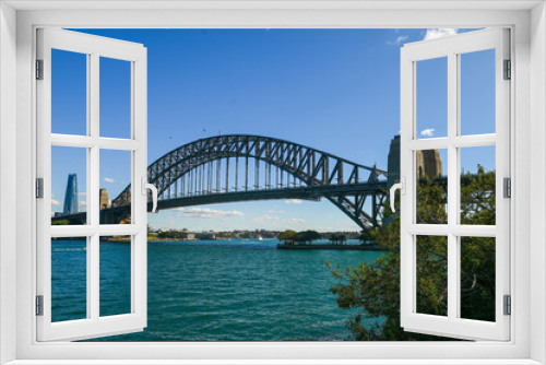 Fototapeta Naklejka Na Ścianę Okno 3D - A view from a tree line of the Sydney Harbour Bridge on a sunny winter day