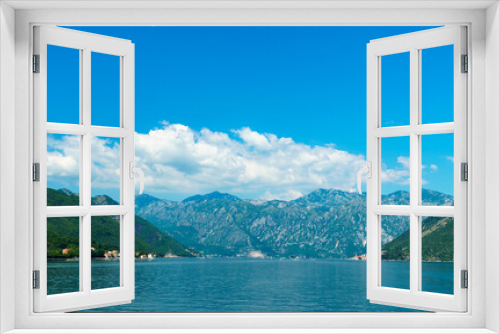 Fototapeta Naklejka Na Ścianę Okno 3D - seascapes, a view of the Bay of Kotor during a cruise on a ship in Montenegro, a bright sunny day, mountains and small towns on the coast, the concept of a summer trip