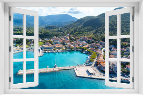 Fototapeta Naklejka Na Ścianę Okno 3D - Aerial view of the port of the coastal village of Vasiliki in the south of the island of Lefkada, Greece. Beautiful crystal clear turquoise and blue waters