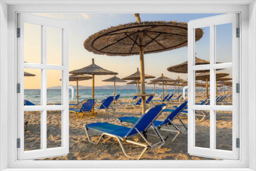 Fototapeta Naklejka Na Ścianę Okno 3D - Sunbeds with umbrella on sandy beach of Marmari. The Greek island of Kos