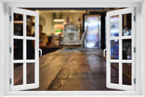 Rustic wooden table at a diner with selective focus and defocused interior