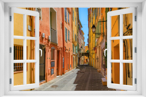 Fototapeta Naklejka Na Ścianę Okno 3D - Picturesque old street light, colorful traditional houses with shutters in the background in the old town of Menton, French Riviera, South of France