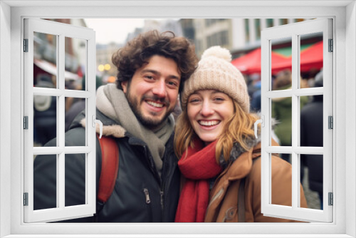 Happy young smiling couple in winter clothes at street Christmas market in Brussel