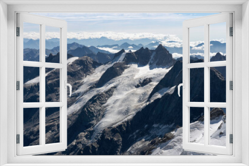 Fototapeta Naklejka Na Ścianę Okno 3D - View from Gran Paradiso (National Park) mountain summit: glaciers of the massif and high rocky peaks. Mountains landscape. Global warming and climate change melting the glacier ice