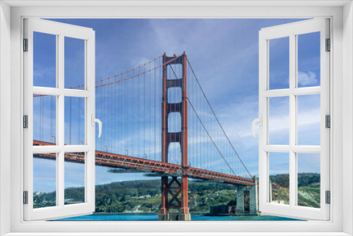 Fototapeta Naklejka Na Ścianę Okno 3D - San Francisco, CA, USA - July 13, 2023: Golden Gate bridge south landing , ocean side, with 1 tower under blue cloudscape. Green hills and city on horizon