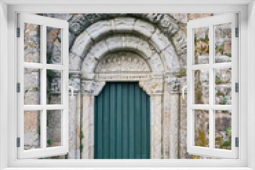 Old stone archway with green door, Santuario de San Xiao de Moraime, Muxia, Galicia, Spain