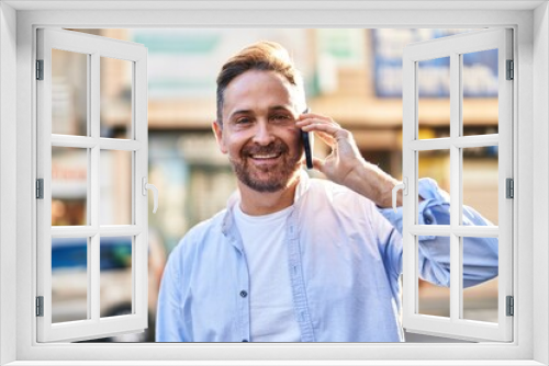 Young caucasian man smiling confident talking on the smartphone at street