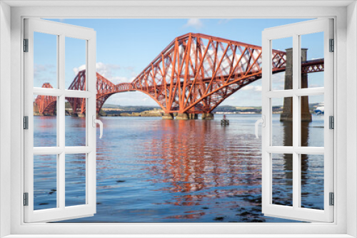 Fototapeta Naklejka Na Ścianę Okno 3D - The Forth Bridge is a railway bridge across the Firth of Forth in Scotland. Is considered a symbol of Scotland, and is a UNESCO World Heritage Site. Designed by  Sir John Fowler and Sir Benjamin Baker