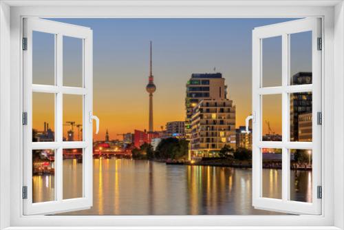 Fototapeta Naklejka Na Ścianę Okno 3D - The river Spree in Berlin after sunset with the famous TV Tower in the back